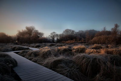 Snow covered landscape against clear sky