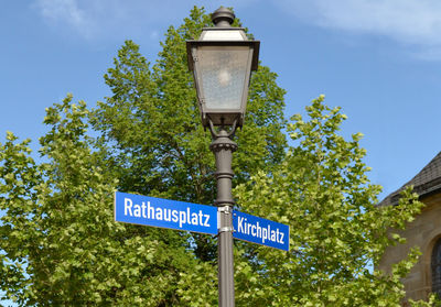 Low angle view of street light against blue sky