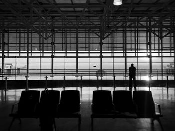 Rear view of silhouette man walking at airport