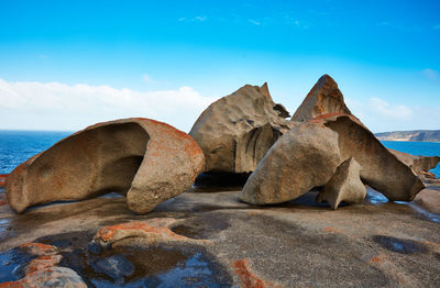 Rocks on beach against sky