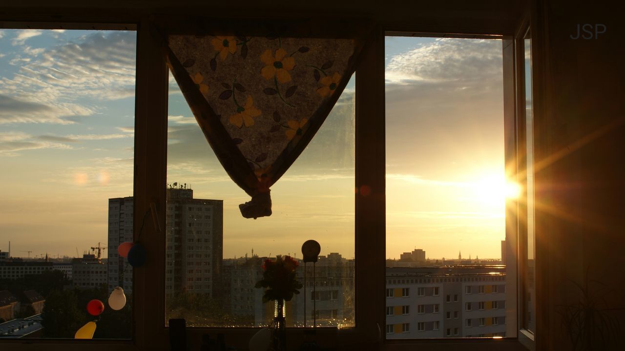 SILHOUETTE OF CITY AGAINST SKY DURING SUNSET