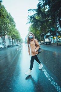 Woman with umbrella on street in city