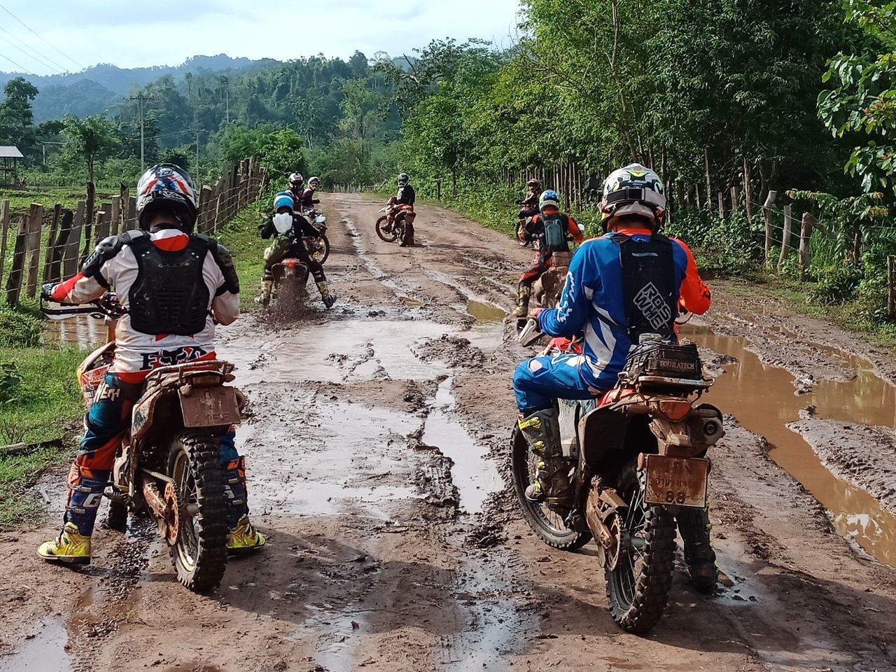 PEOPLE RIDING MOTORCYCLE ON CART