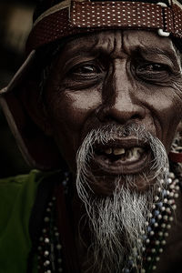 Close-up portrait of a man wearing hat