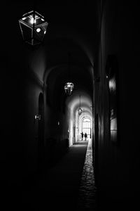 Illuminated pendant lights hanging in darkroom