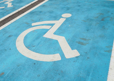 High angle view of wheelchair disabled sign on road