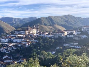 High angle view of townscape and mountains against sky