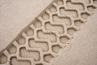 Close-up of tire track in sand