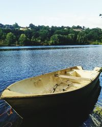 Boats moored in lake against sky