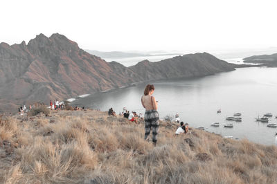 Panoramic view of people on land against sky