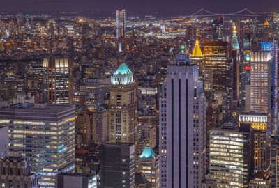 High angle view of city lit up at night