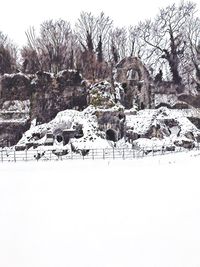 Snow on landscape against clear sky