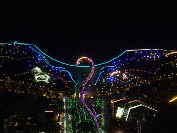 Illuminated ferris wheel at night