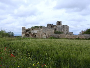 Historic building on field against sky