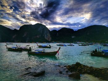 Boats moored on sea against sky