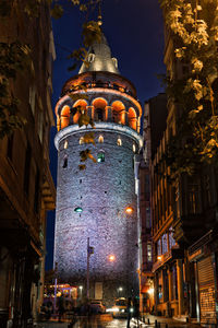Low angle view of illuminated tower in old town