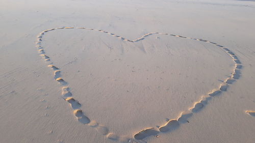 High angle view of heart shape on sand