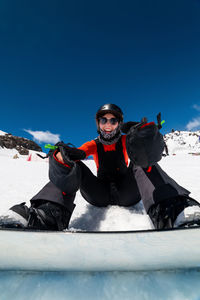 Low angle view of people skiing in snow