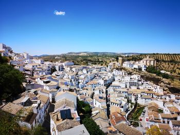 High angle shot of townscape against blue sky