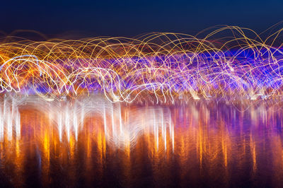 Multi colored light effect against sky at night