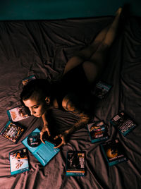 High angle view of woman relaxing on bed at home