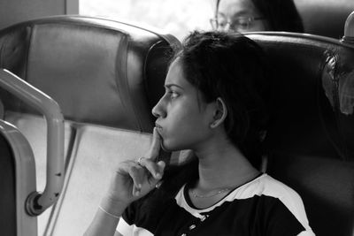 Thoughtful woman traveling in train