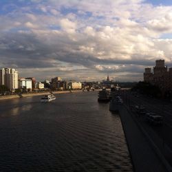 Cityscape against cloudy sky