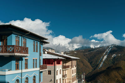 Low angle view of buildings against cloudy sky