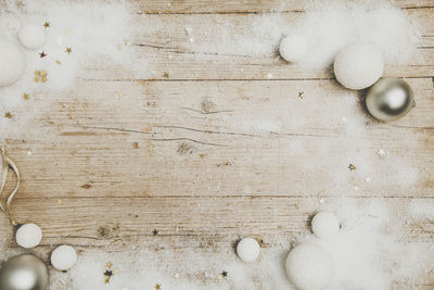 Directly above shot of christmas decorations on wooden table