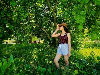 Young woman standing on tree