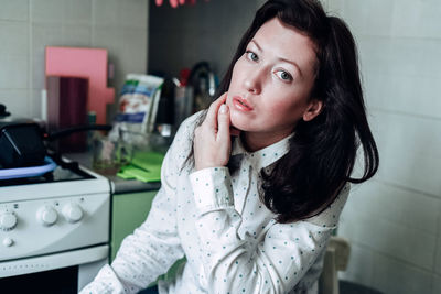 Portrait of beautiful woman sitting at home