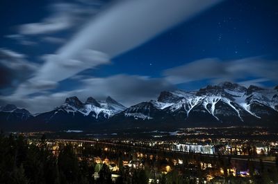 Scenic view of snowcapped mountains against sky at night