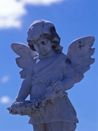 Low angle view of statue against blue sky