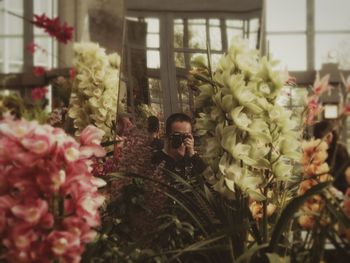 Man photographing flowers at miracle planet museum of plants