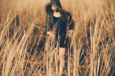 Woman walking on grassy field