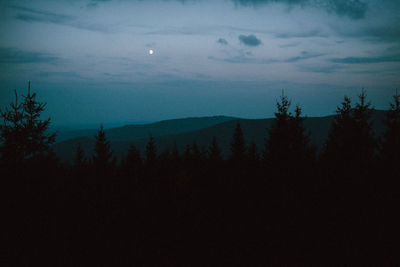 Scenic view of silhouette landscape against sky at night