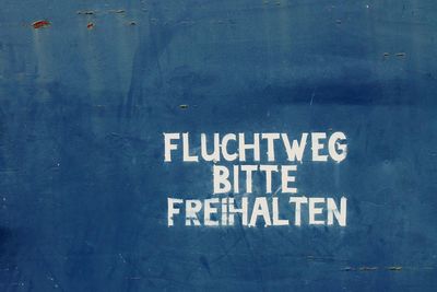 Text on blue wall