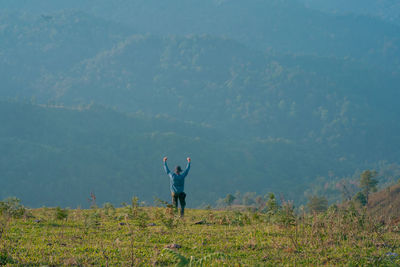 Hiker man relax with wellbeing and happy feeling on top of mountain