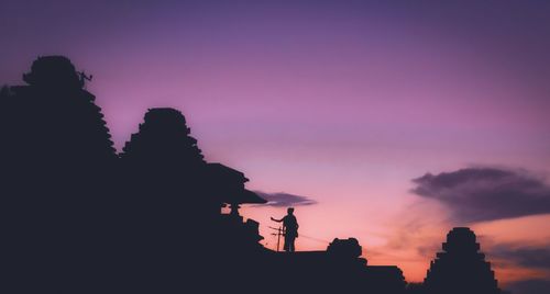 Low angle view of silhouette buildings against sky during sunset