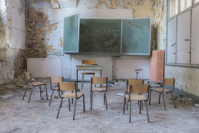 Chairs and table in abandoned classroom