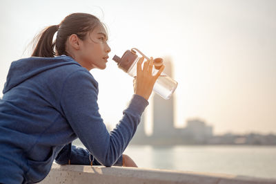 Side view of a woman drinking water