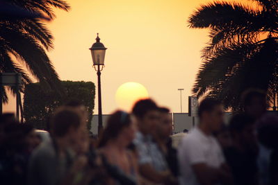People on street during sunset