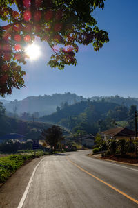Road amidst trees against sky