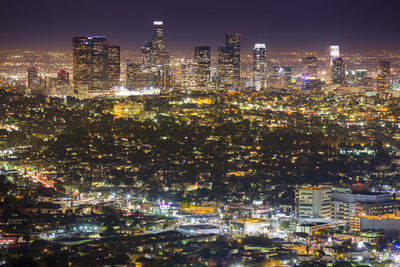 High angle view of city lit up at night