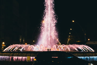 Low angle view of firework display against sky at night