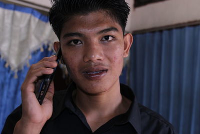 Portrait of young man using mobile phone