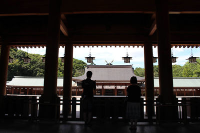 Rear view of people walking in temple building