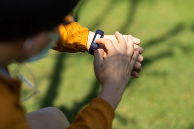 Midsection of man holding leaf