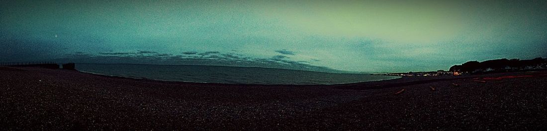 Scenic view of beach against sky at night