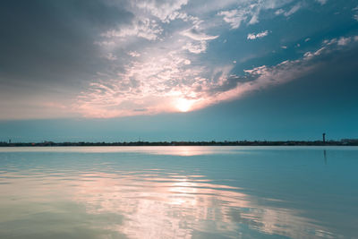 Scenic view of river against sky during sunset